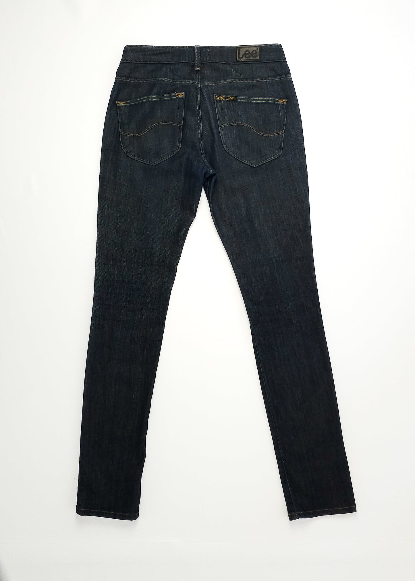 Dark wash skinny jeans viewed from the back, featuring two rear pockets with yellow stitching and a Lee brand patch on the waistband.