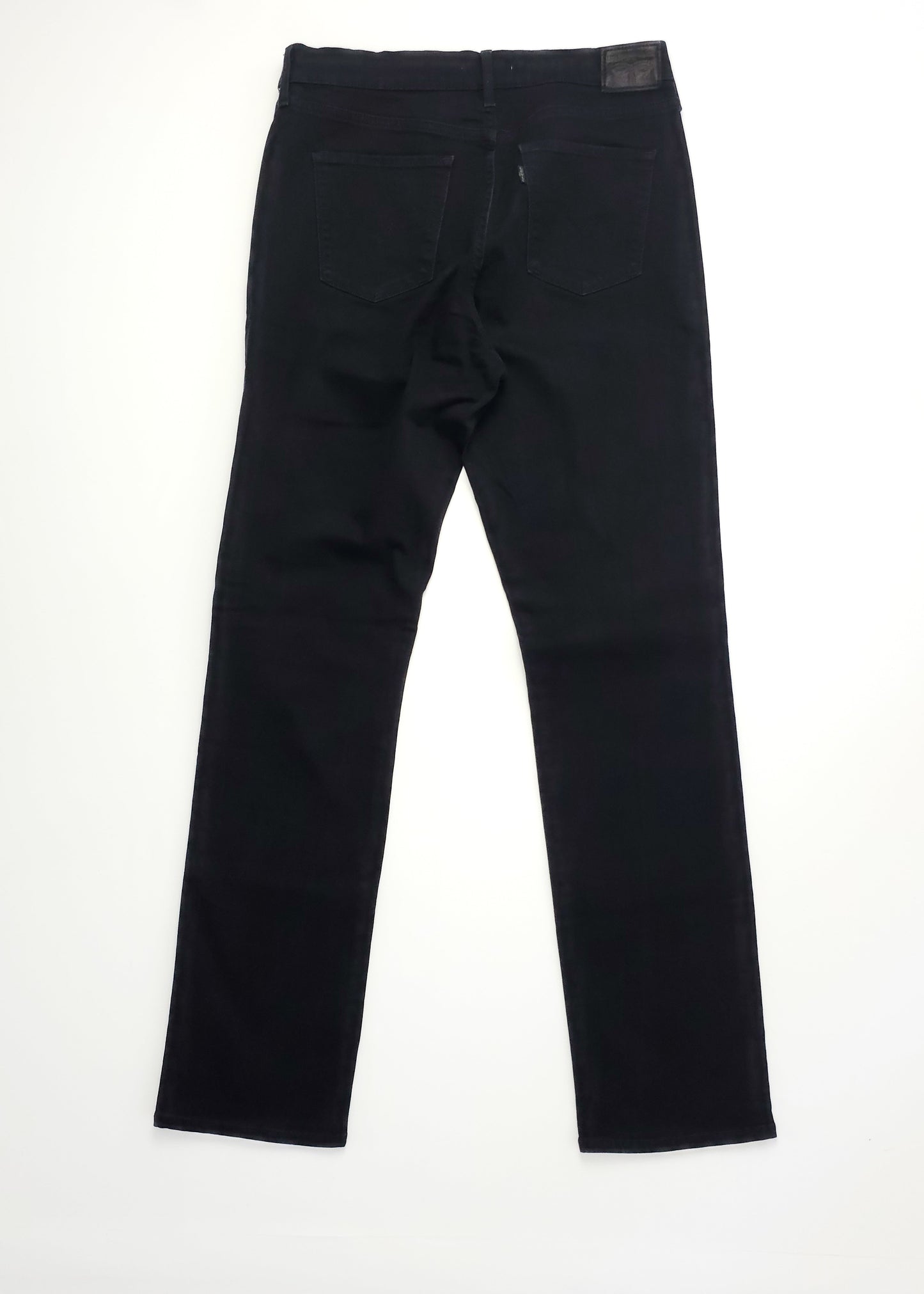 A pair of black jeans with a straight leg cut, viewed from the back. They feature two back pockets and a leather patch at the waistband.