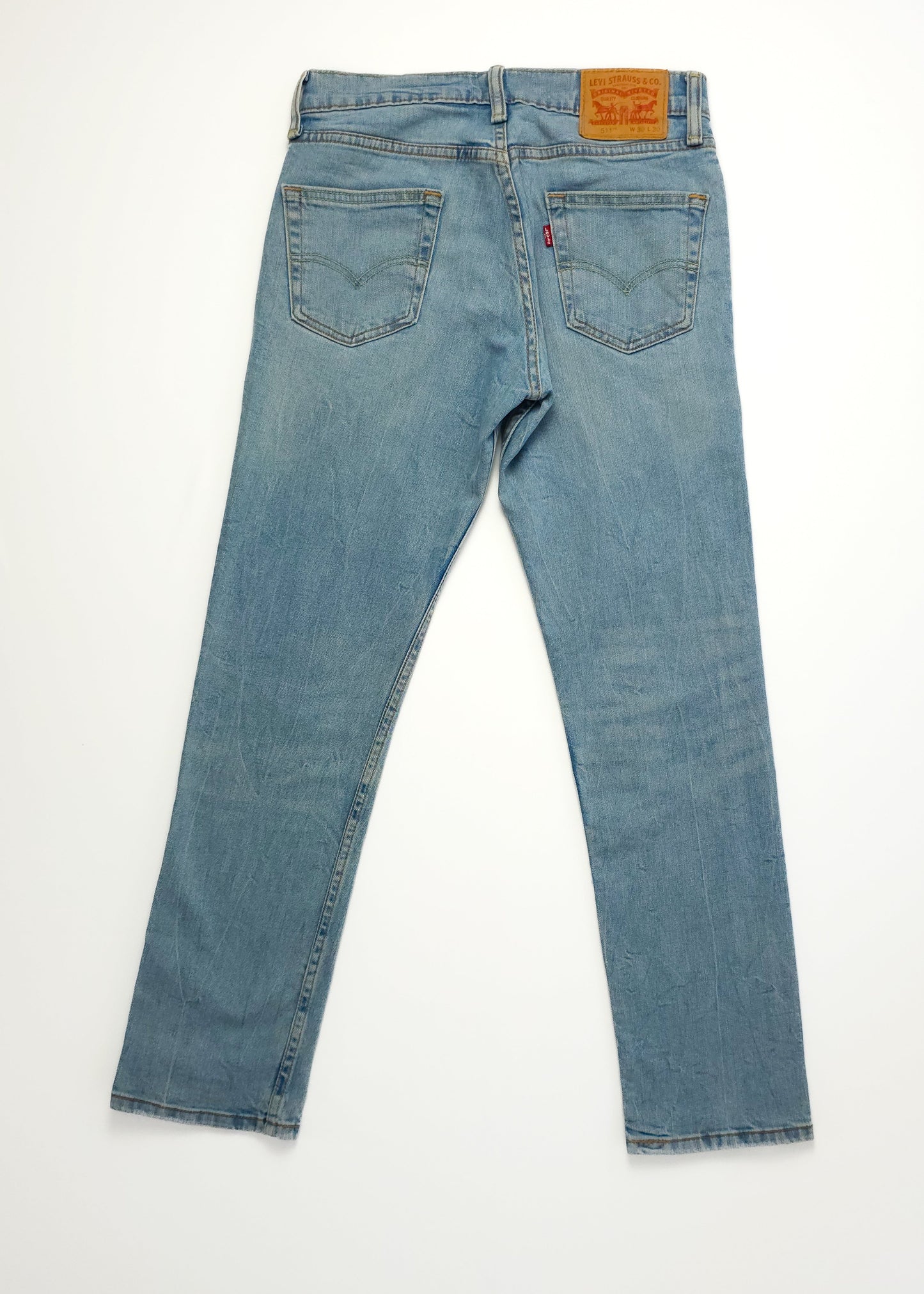 Light blue denim jeans with a high waist and straight leg fit, featuring a leather patch on the back waistband and two back pockets.