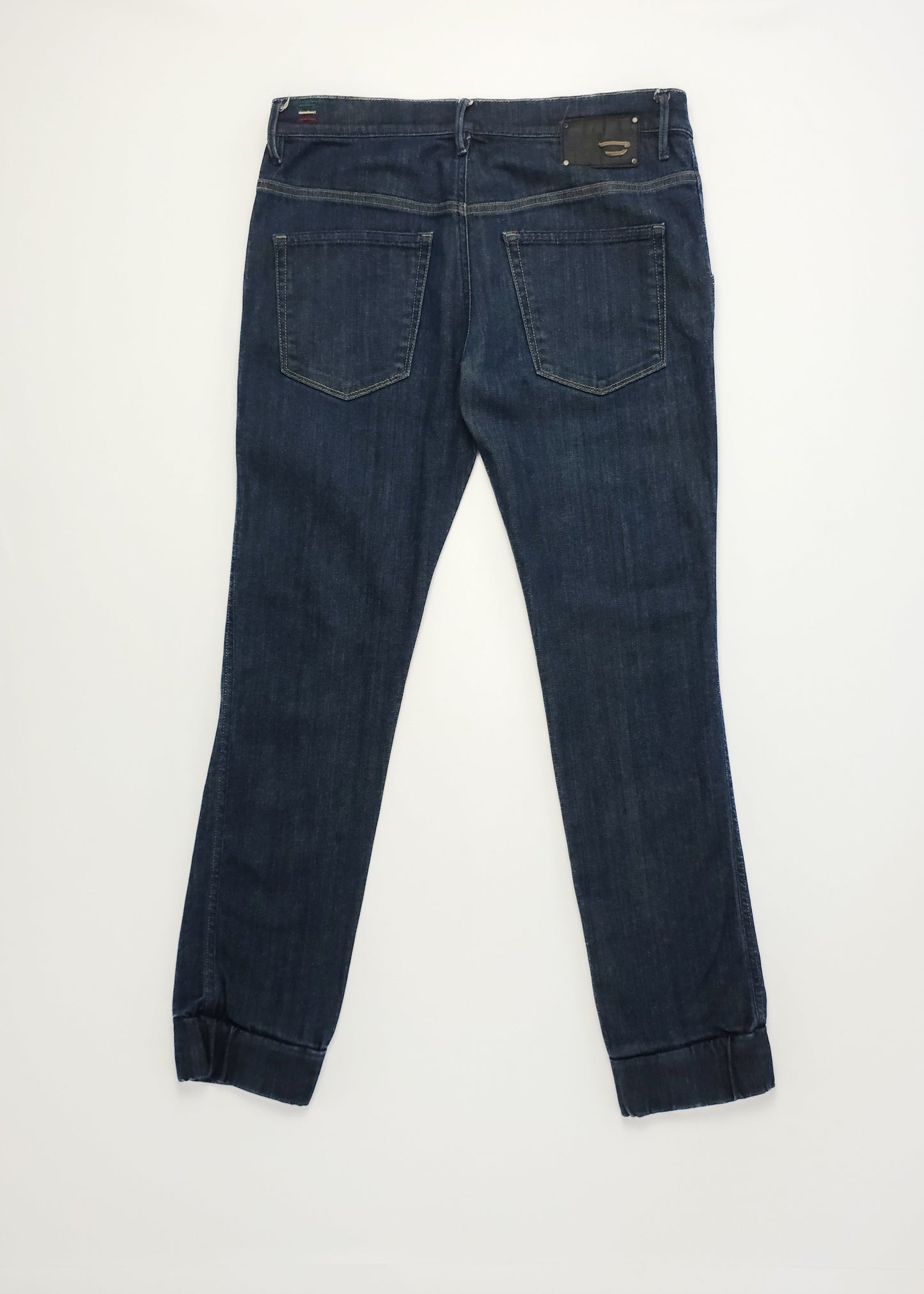 Dark blue Diesel jeans with a straight fit and classic pocket design.