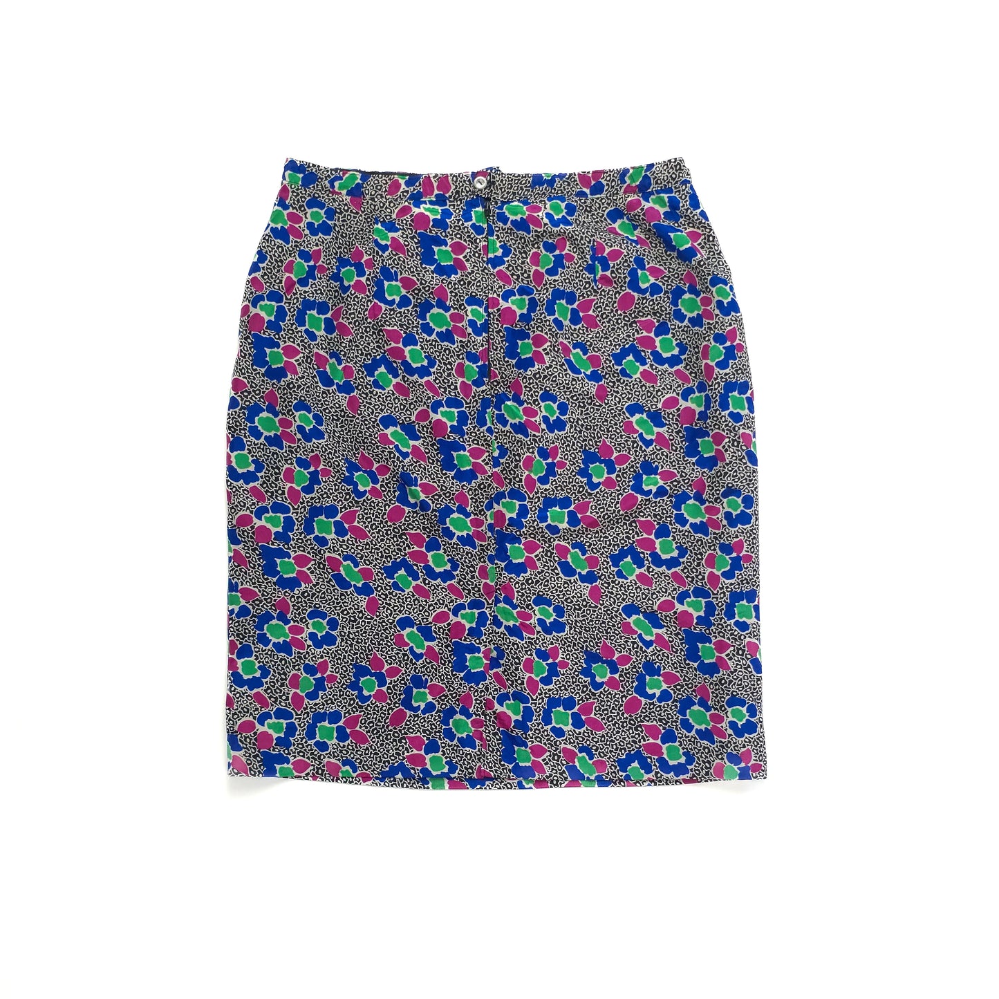 A women's knee-length vintage skirt with a colorful abstract pattern featuring blue, green, and pink shapes on a black and white dotted background.