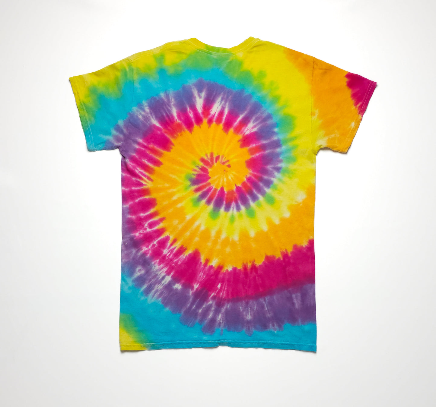 Vibrant tie-dye t-shirt with a spiral pattern in yellow, orange, pink, purple, and blue on a plain white background.