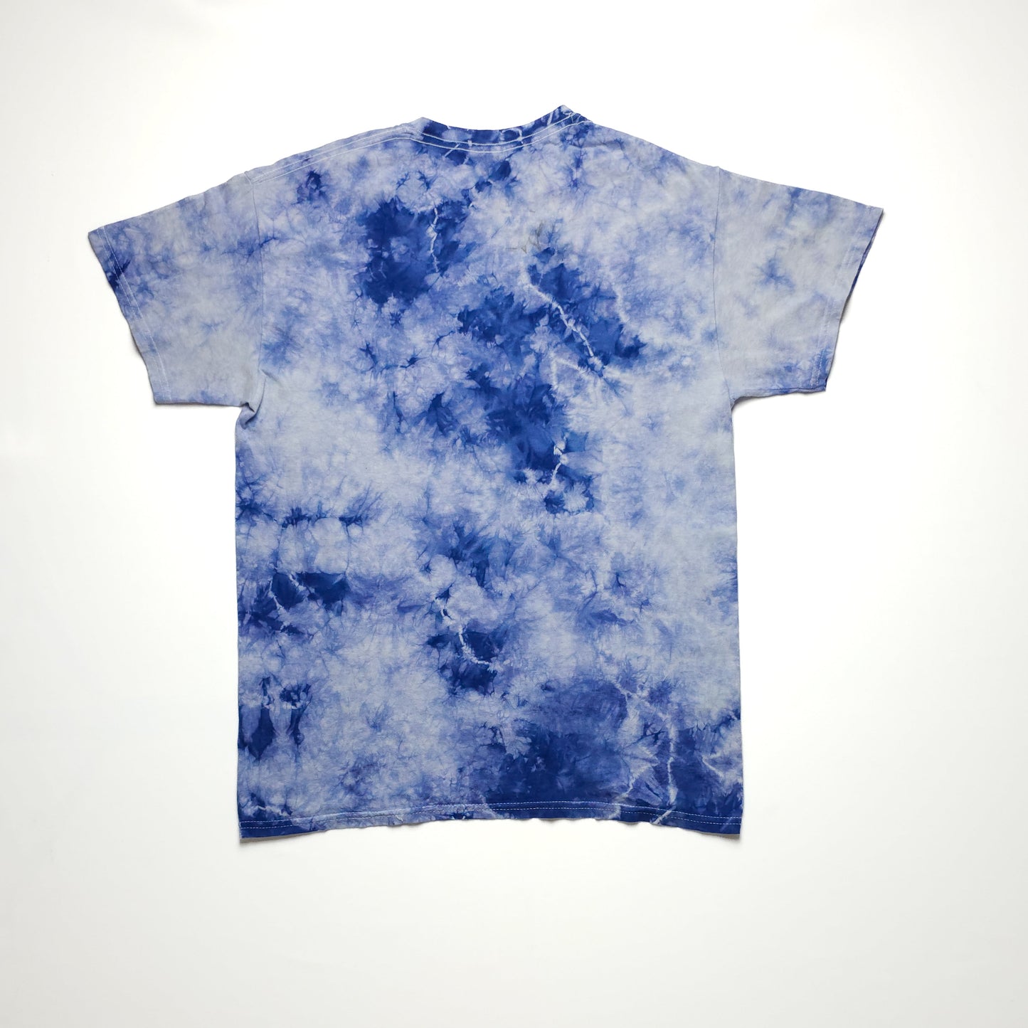 Blue and white tie-dye t-shirt displayed on a plain white background, showcasing a unique swirling pattern with short sleeves and a relaxed fit.