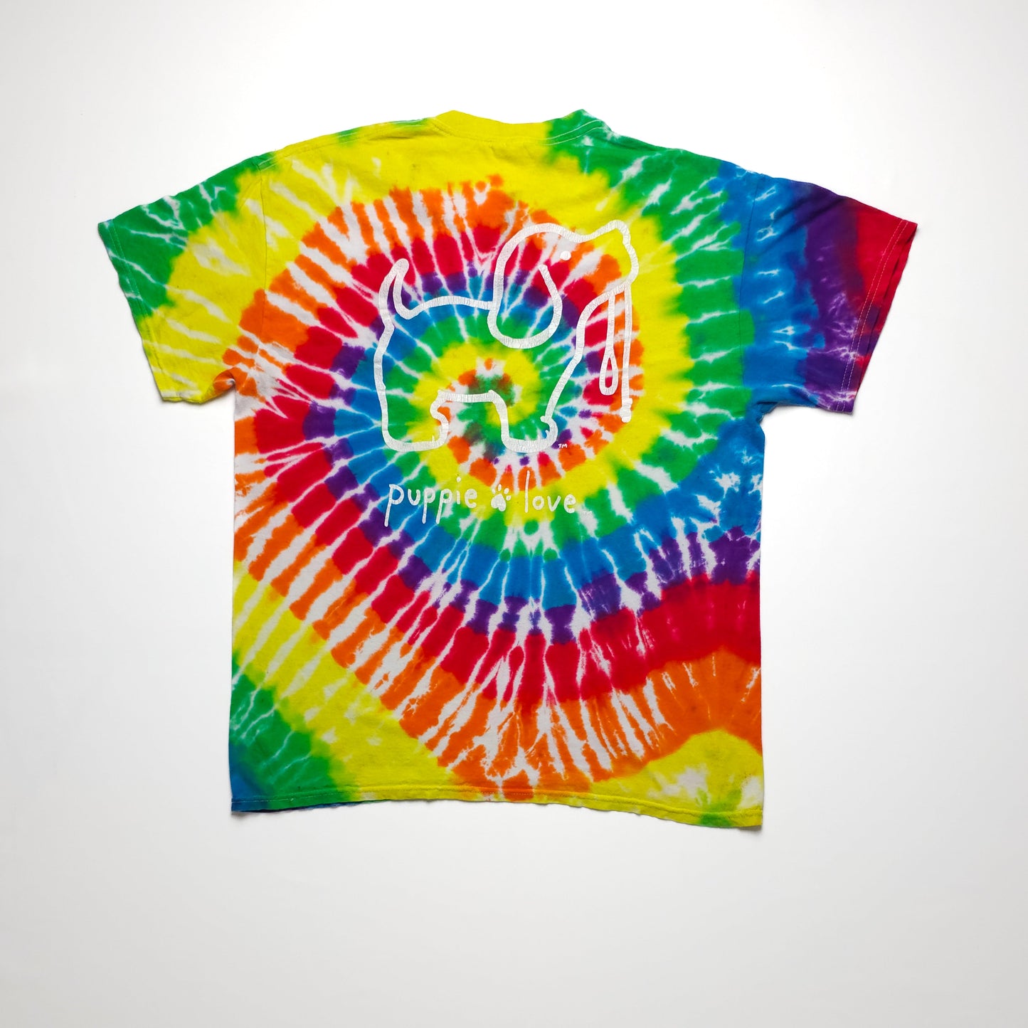 Colorful tie-dye t-shirt with vibrant rainbow spiral pattern and a white outline of a dog with "puppie love" text in the center.
