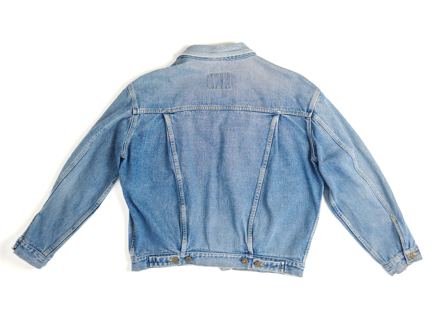 A light blue vintage denim jacket with a faded wash, featuring long sleeves, a straight cut, and button cuffs. The back of the jacket is shown.
