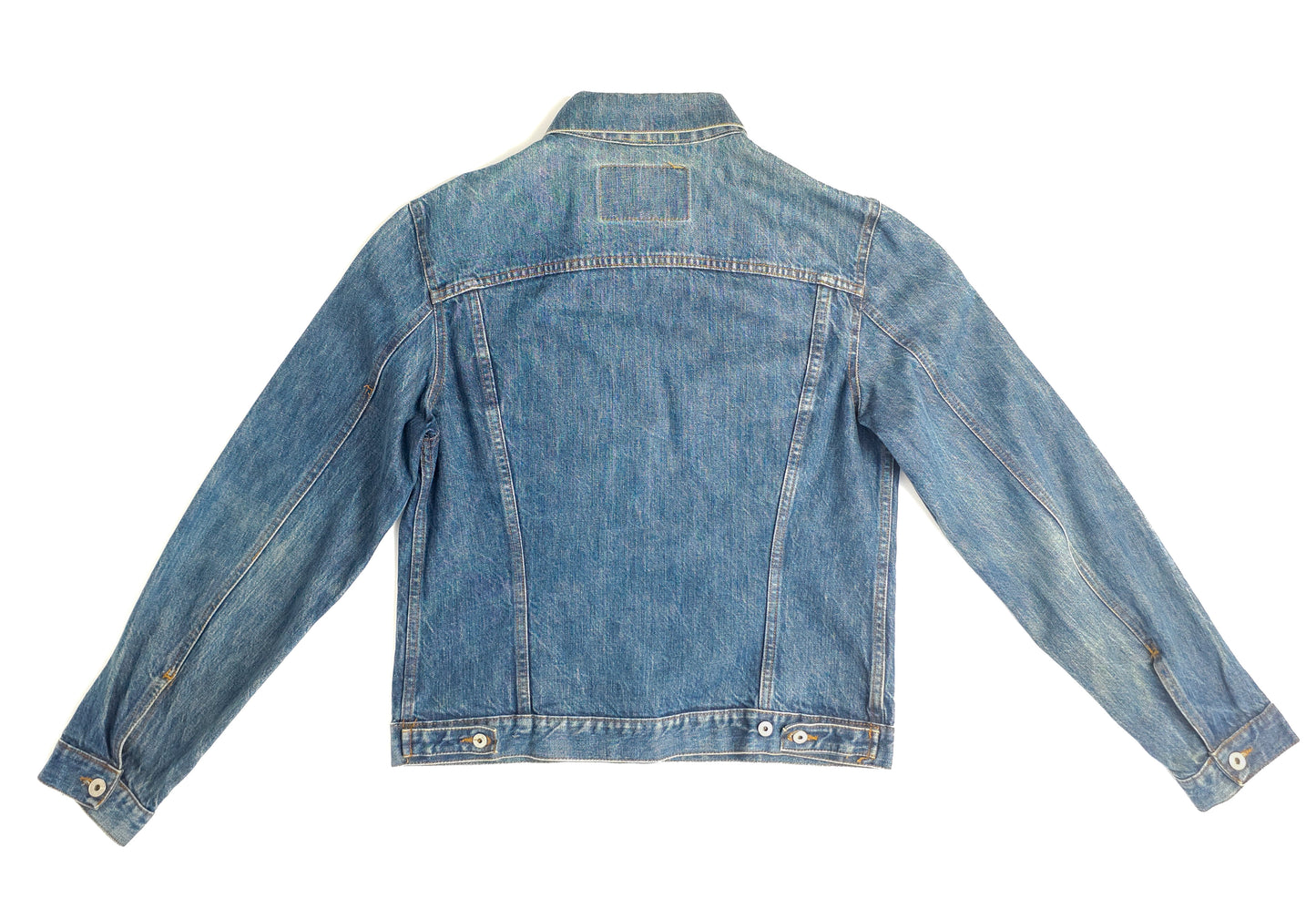 A light blue denim jacket with long sleeves, visible front stitching, and button details on the cuffs and waistband, laid flat with the back facing up.