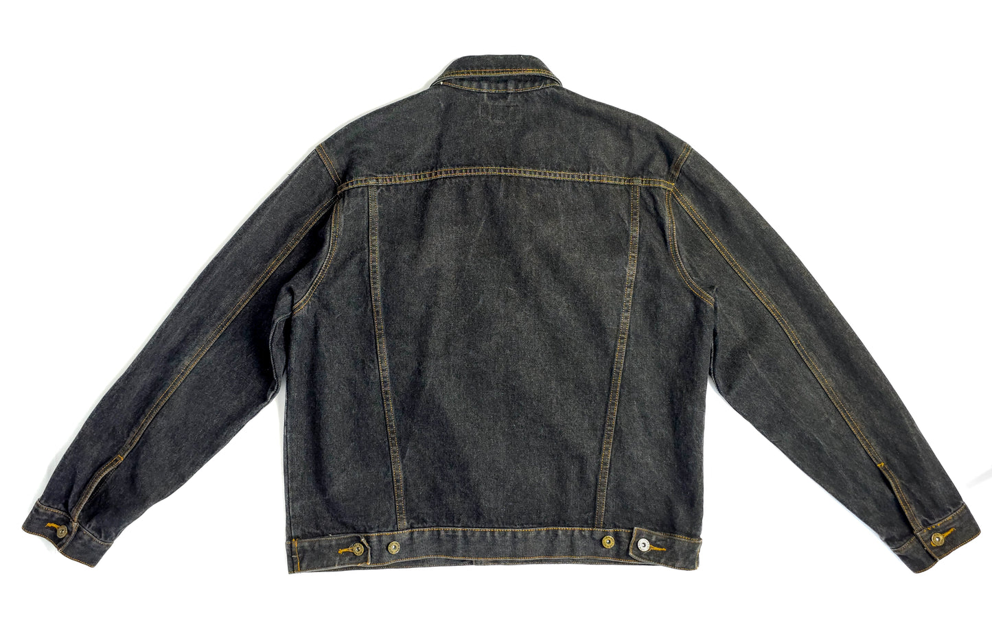 A vintage black denim jacket with yellow stitching, long sleeves, and button details. The back view is shown, highlighting the clean, classic design.