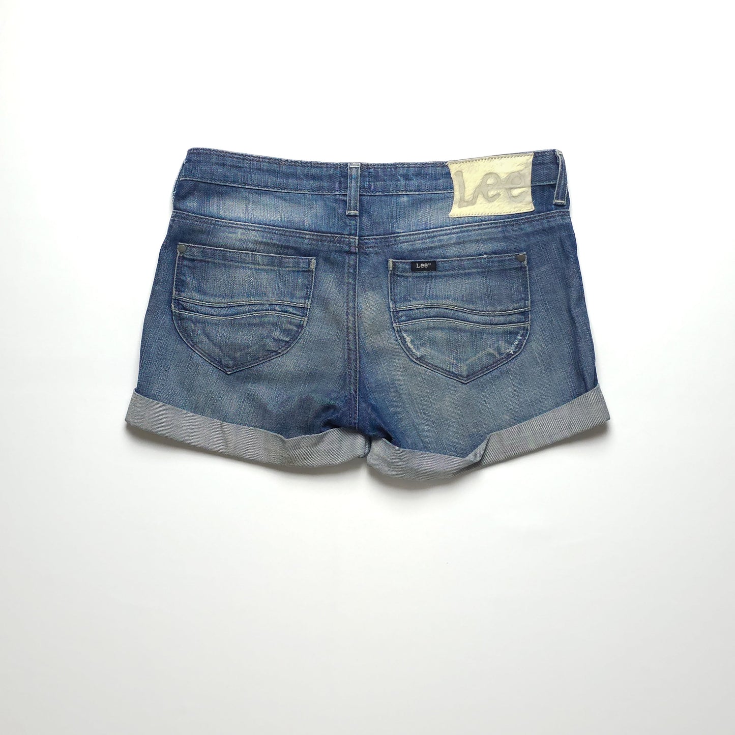 A pair of blue denim shorts with rolled cuffs, two back pockets, and a Lee label on the waistband, displayed on a white background.