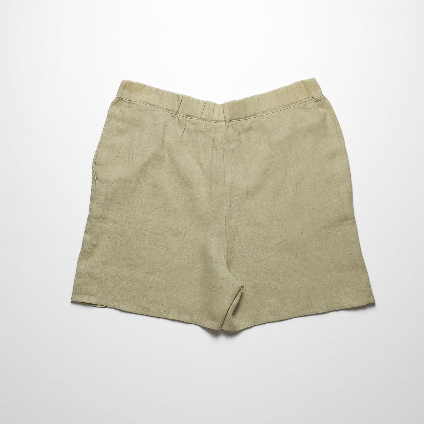 Khaki green linen shorts with an elastic waistband, displayed on a plain white background. The shorts have a simple, minimalist design without any visible pockets or embellishments.