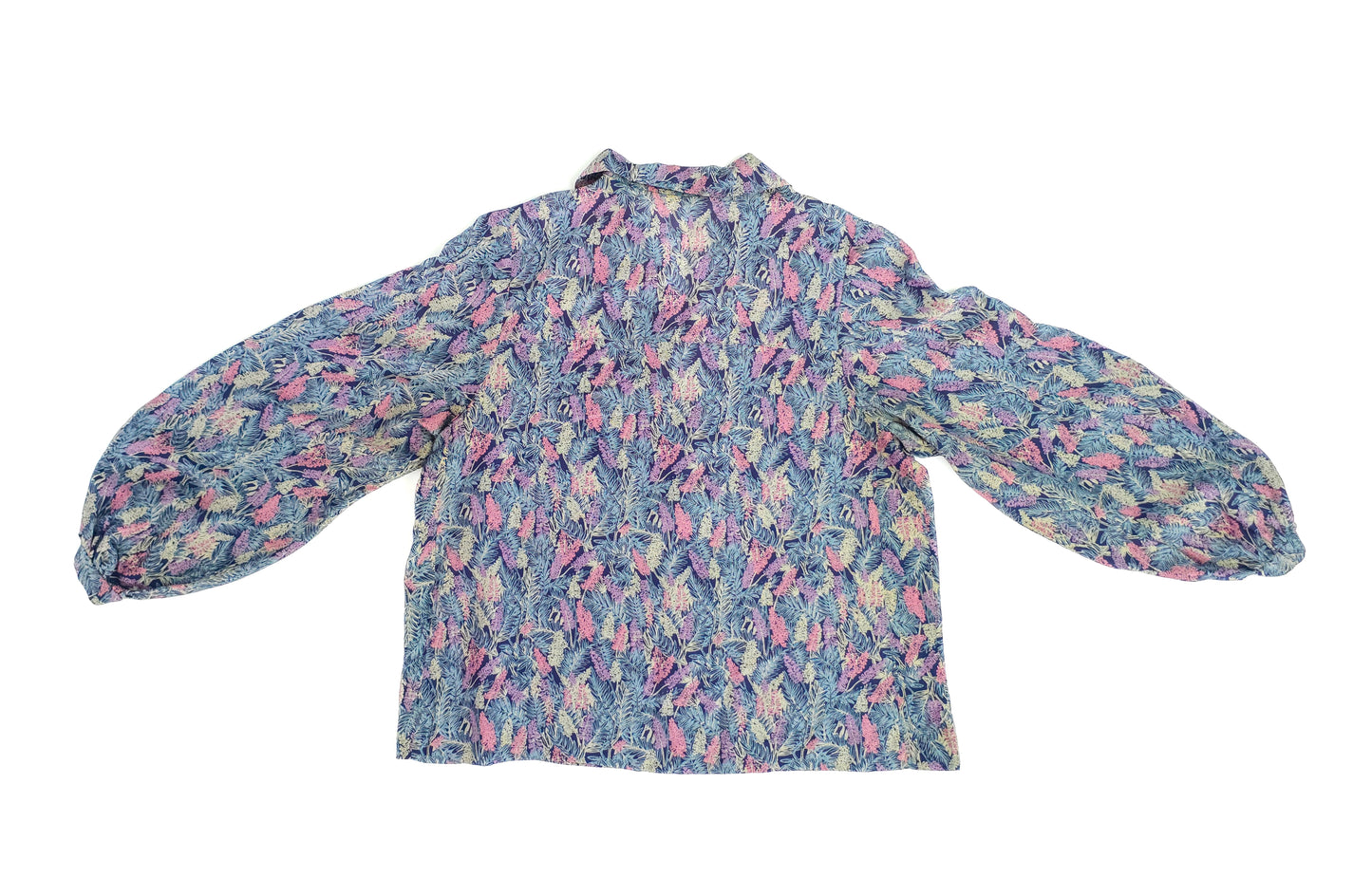 A vintage long-sleeve blouse with a vibrant pattern of pink, purple, and blue abstract designs, featuring a loose fit and button-up front.