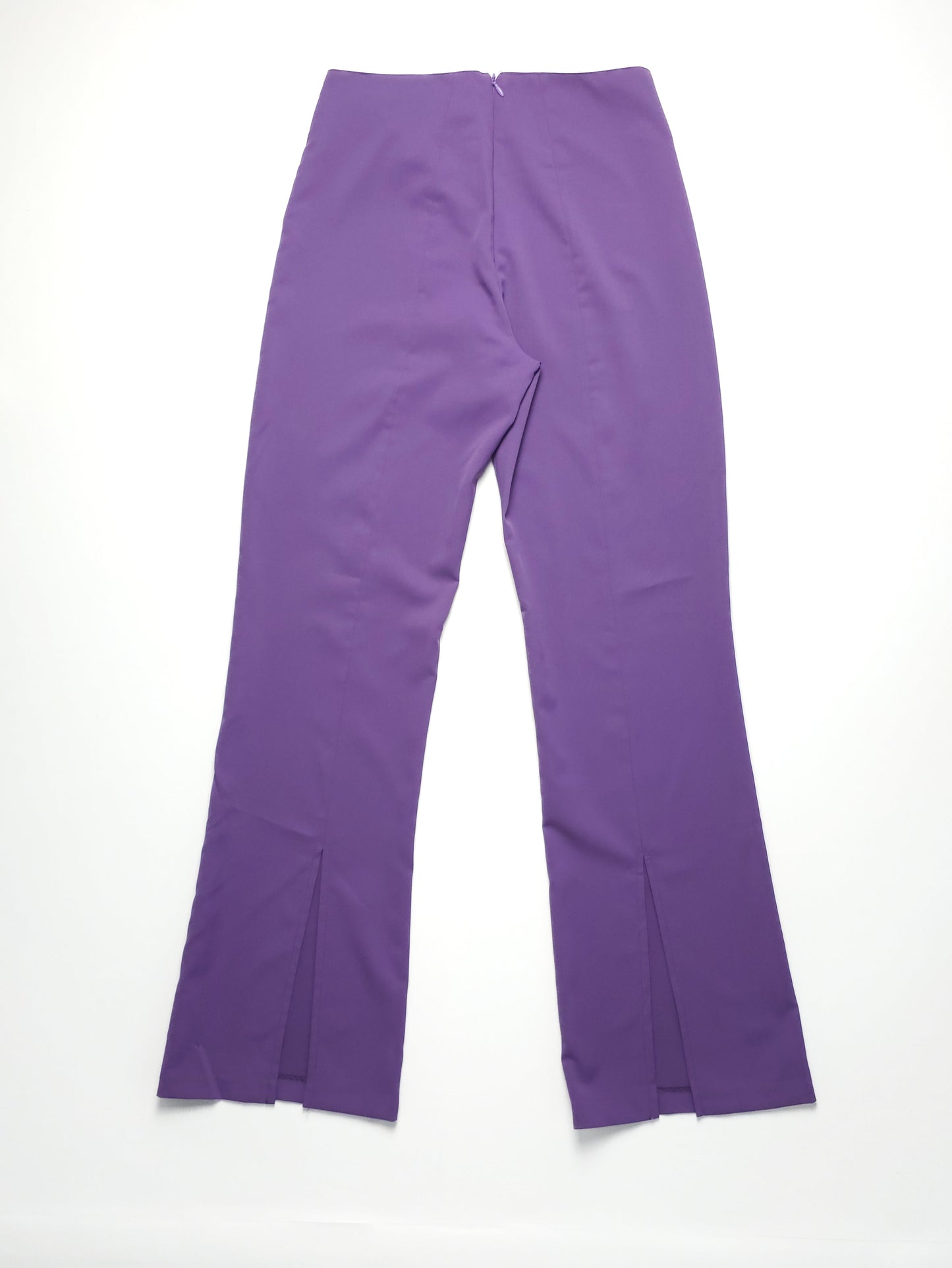 Purple high-waisted pants with flared legs and front slits, laid flat on a white background.