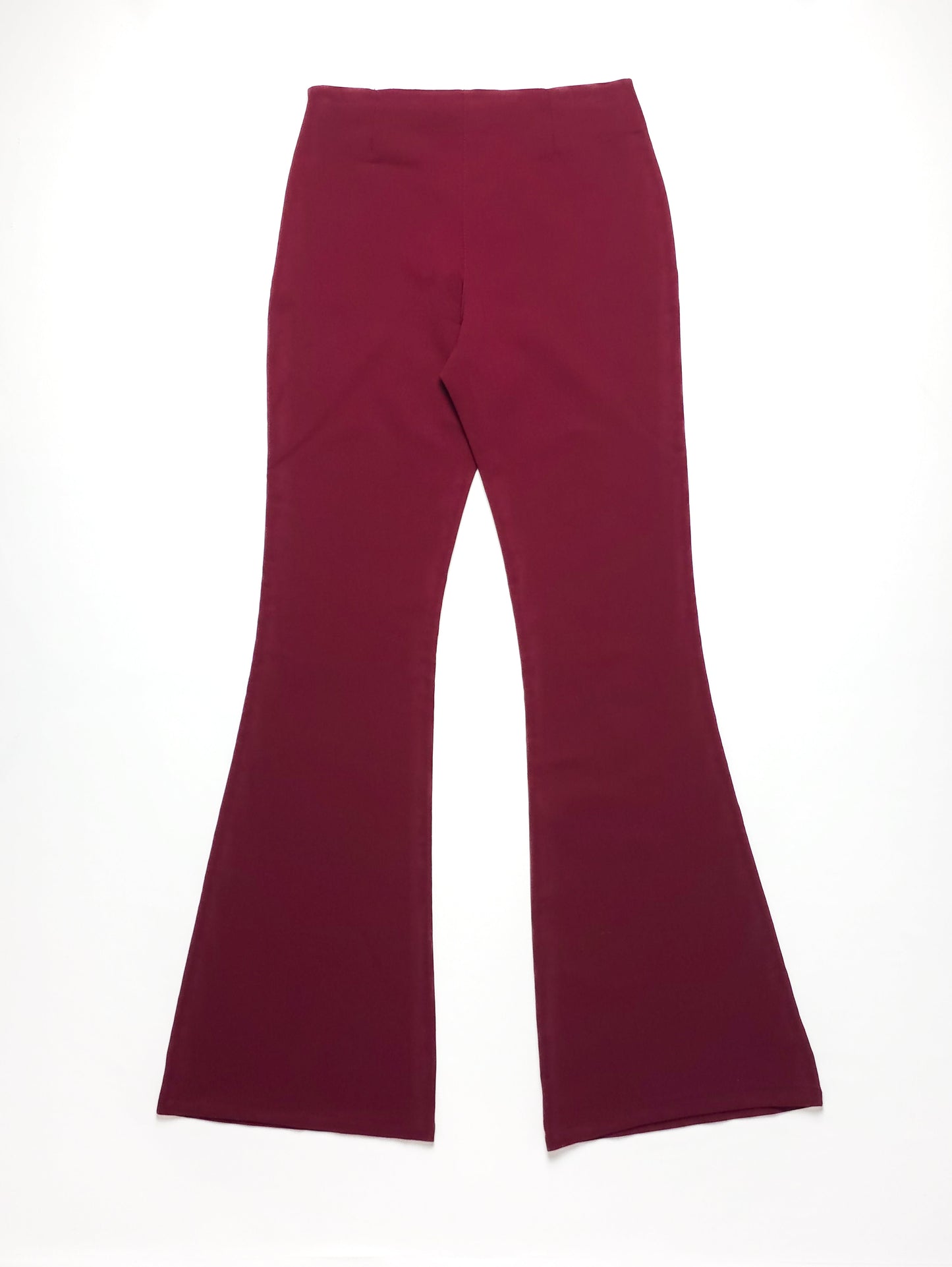 Red flare pants with a high waist, laid flat against a white background. The fabric appears smooth and slightly stretchy.