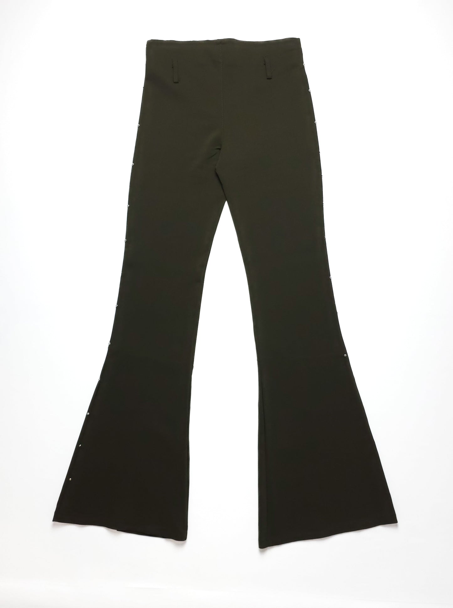 A pair of black flared pants with button detailing along the sides, laid flat against a white background. The pants have a high waist and long hem.