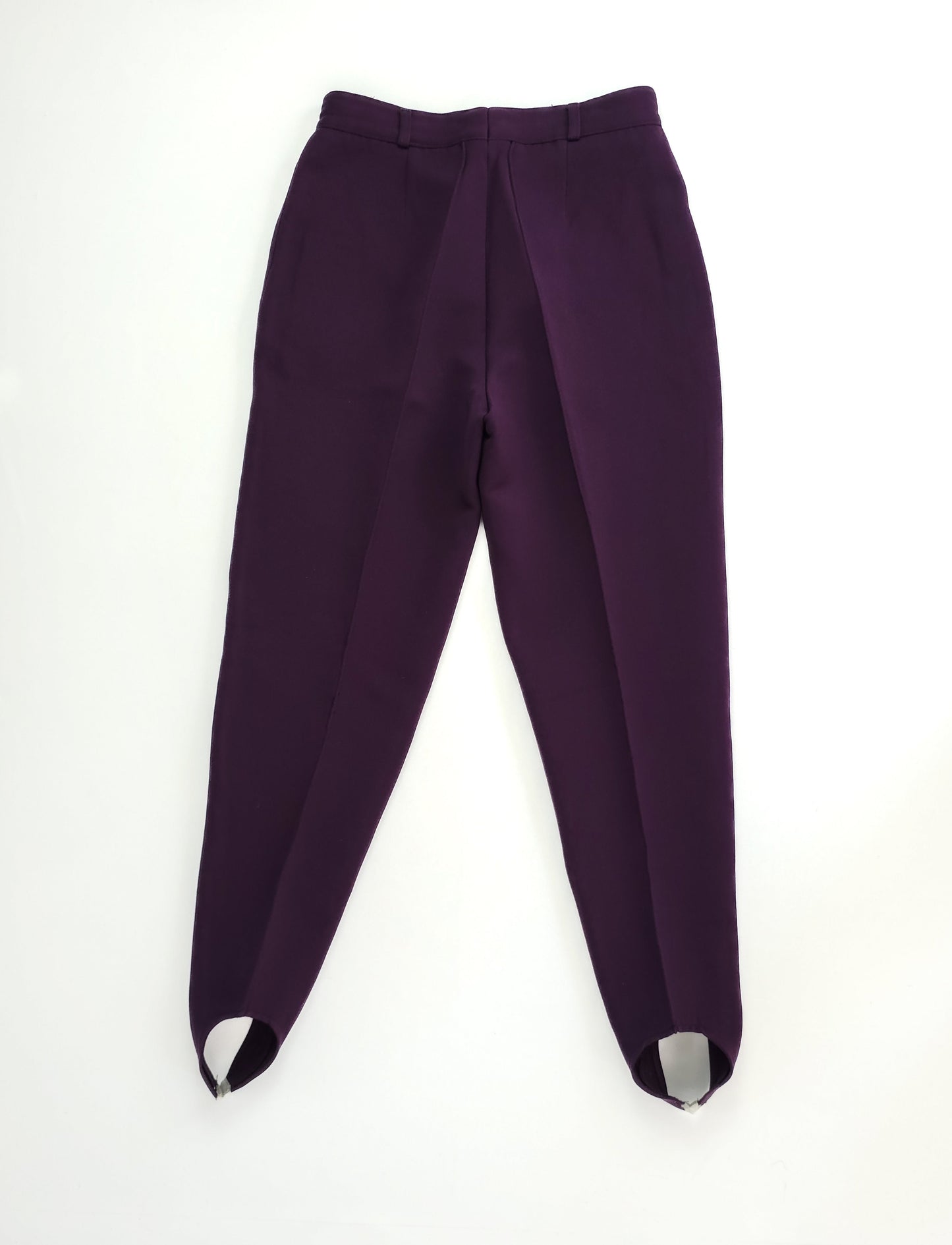 Purple high-waisted stirrup pants with pleats, tailored fit, and ankle straps, displayed on a white background.