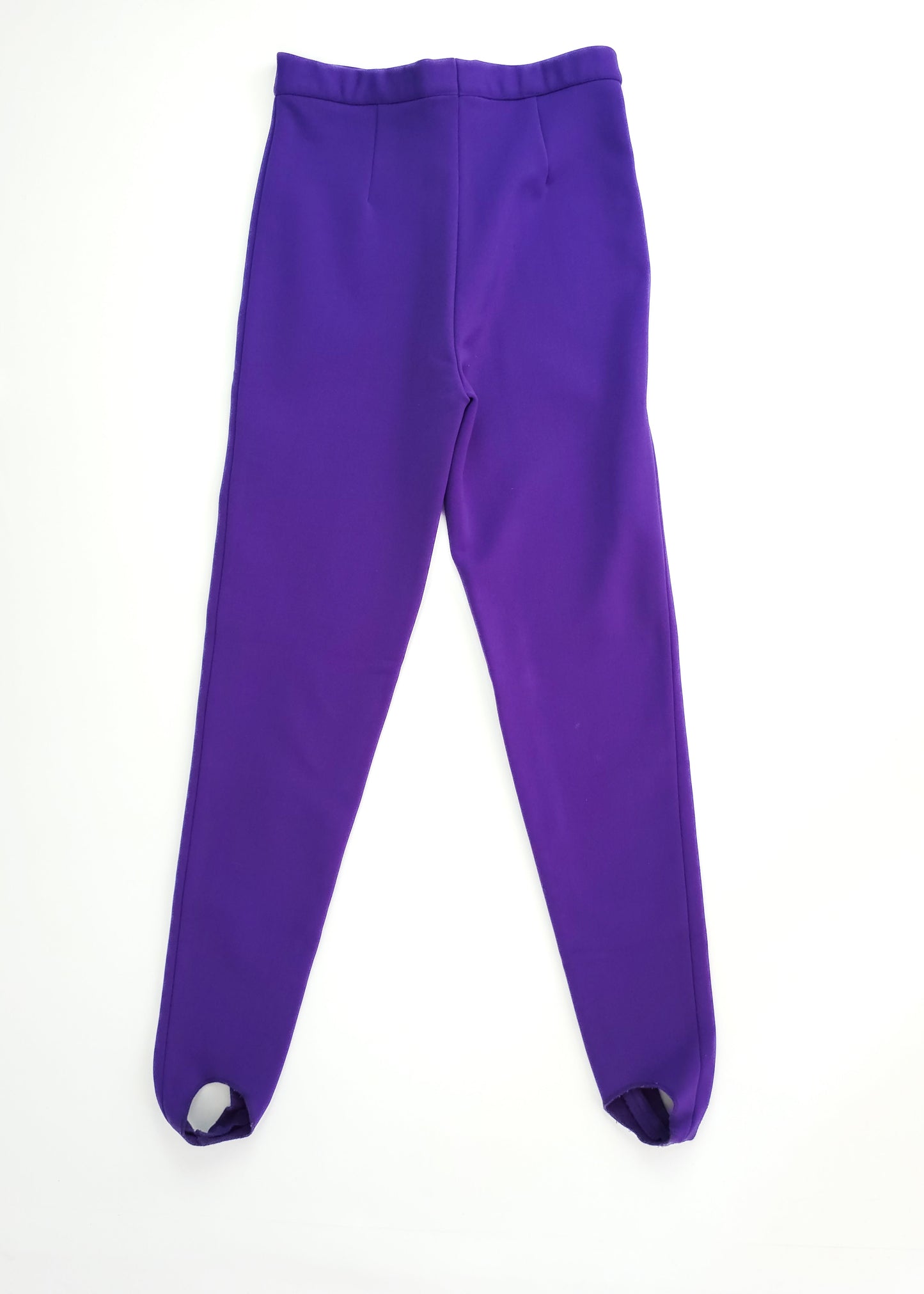 Bright purple, high-waisted, ankle-length leggings with stirrups, laid flat on a white background.