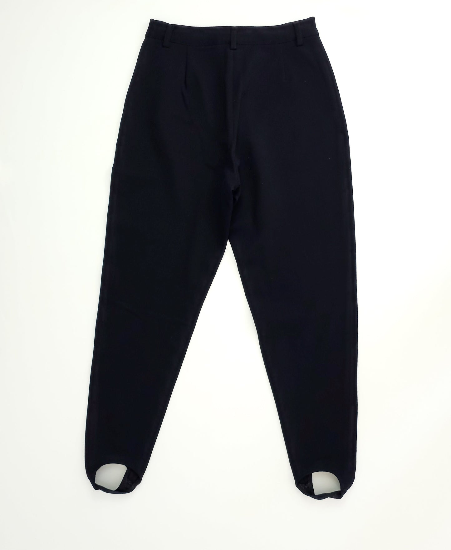 Black high-waisted pants with pleats and elastic stirrups, displayed flat on a white background.