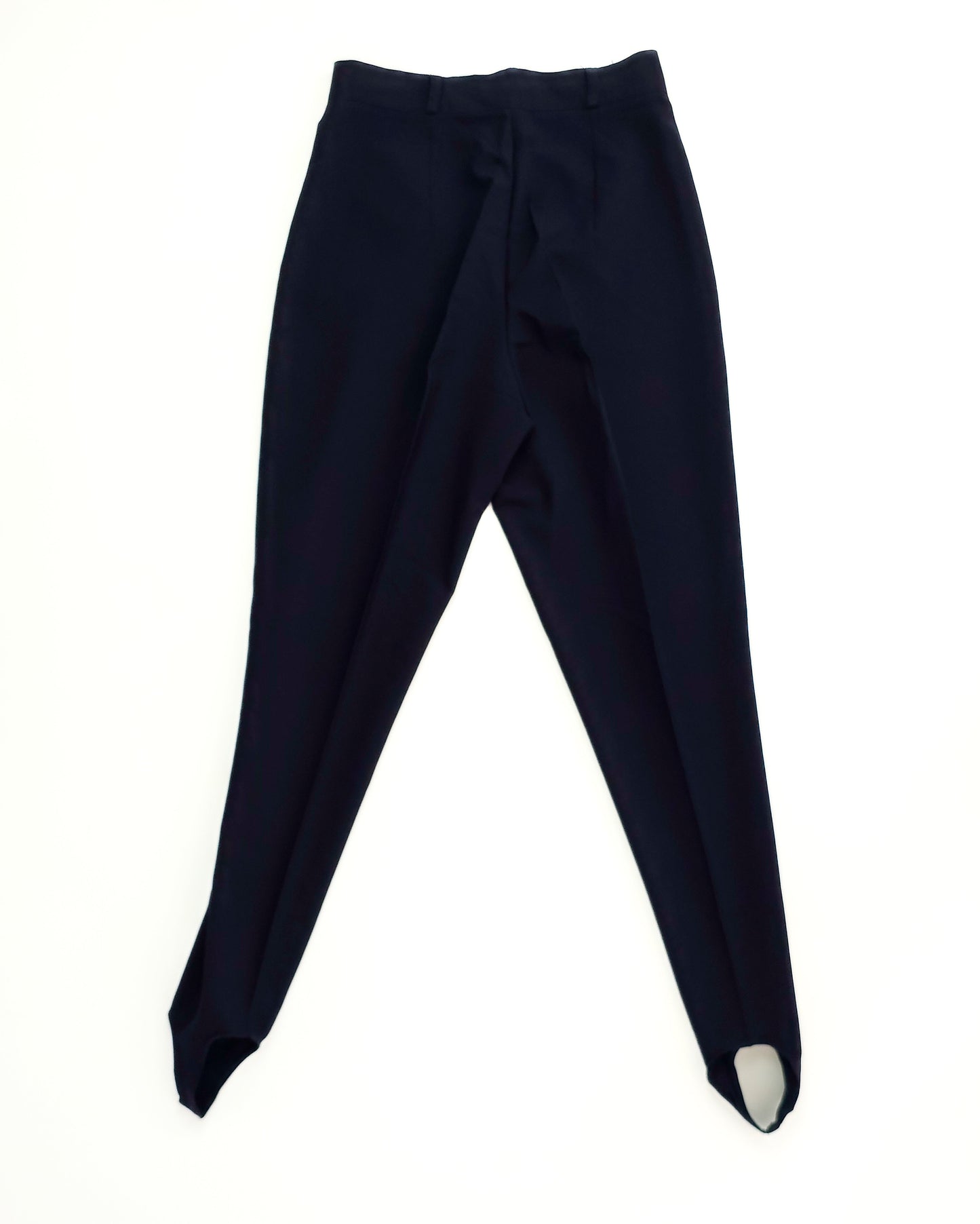 Black stirrup pants with a high waist and tapered legs, laid flat on a white background.