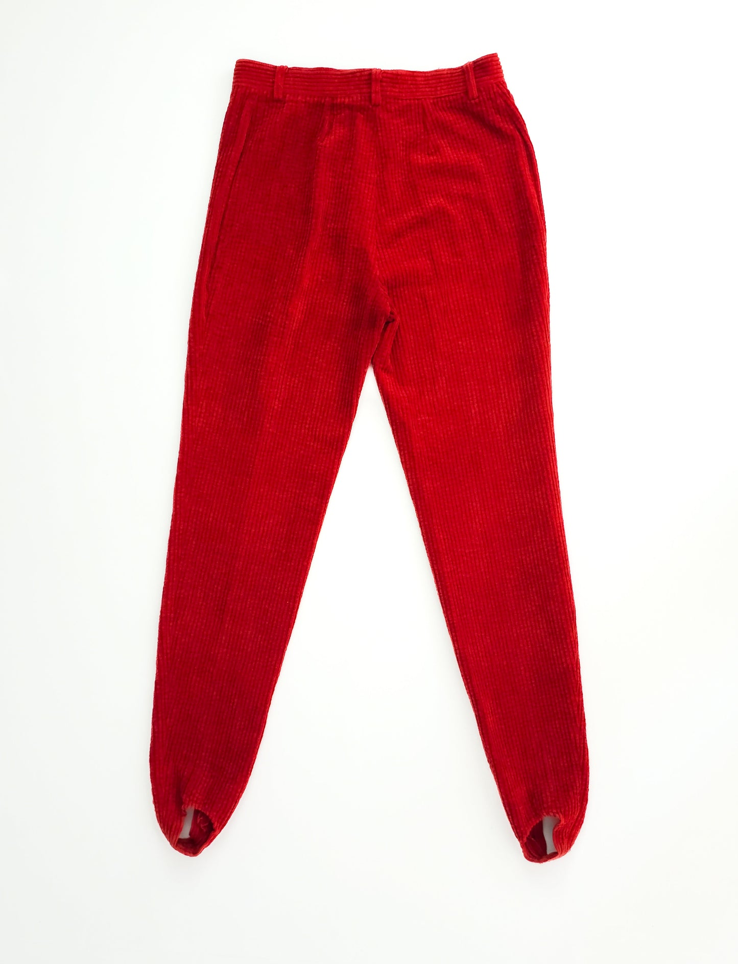 Bright red corduroy leggings with an elastic waistband and stirrup design, laid flat on a white background.