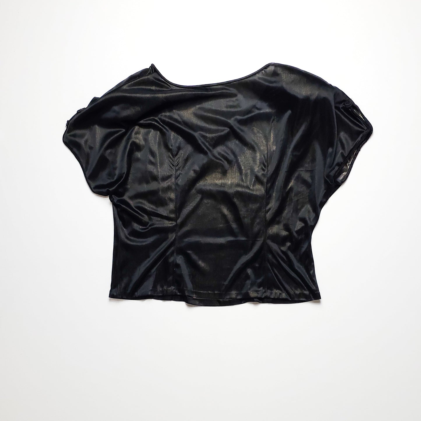 A shiny black leather short-sleeve top with a relaxed fit, laid flat against a plain white background, showcasing its sleek and smooth texture.