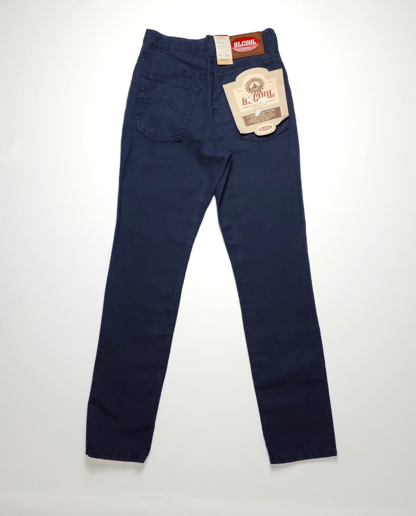 Dark navy straight-leg jeans with back pockets, a vintage label on the waistband, and a brand tag attached, displayed on a flat white surface.