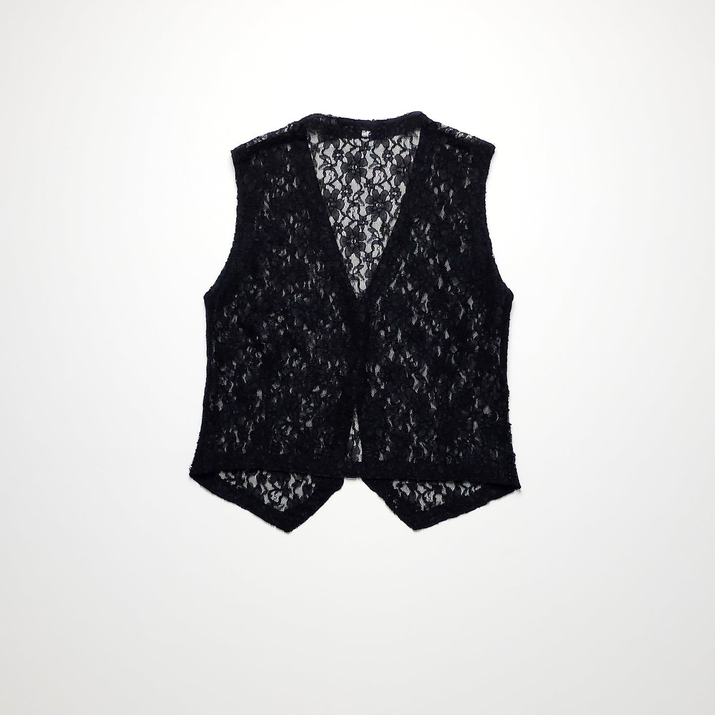 A sleeveless black lace vest with a floral pattern, featuring an open front design. The delicate lace fabric creates a semi-sheer look against a plain background.