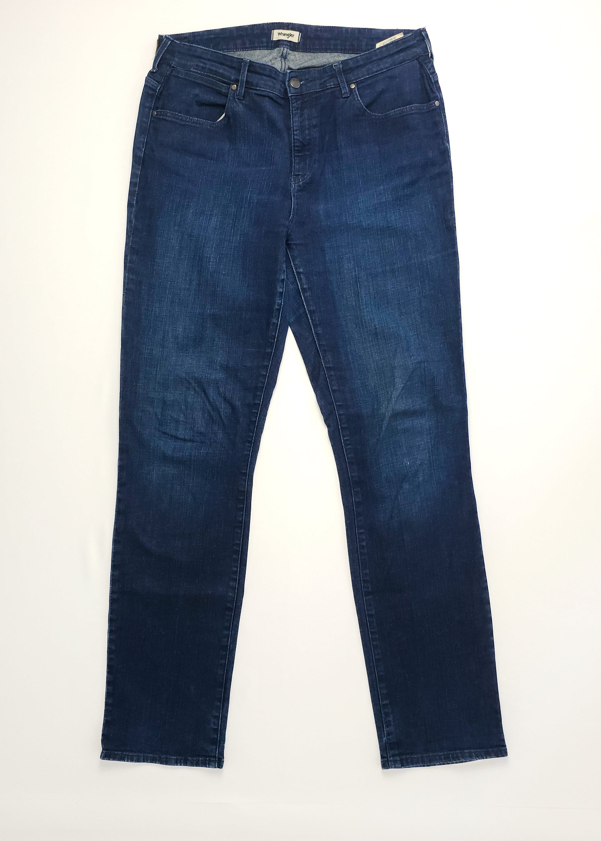 Dark blue Wrangler denim jeans laid flat.