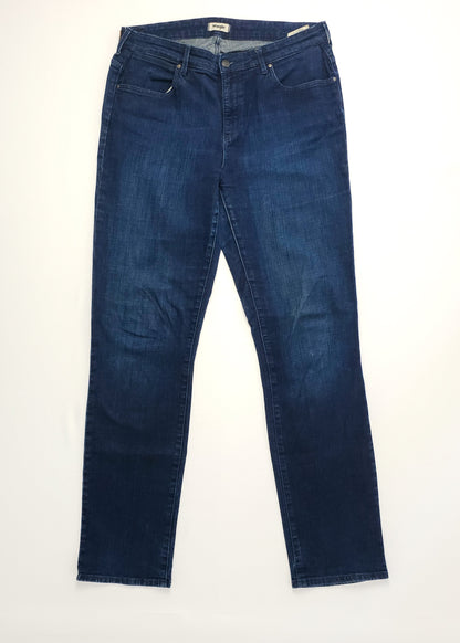 Dark blue Wrangler denim jeans laid flat.