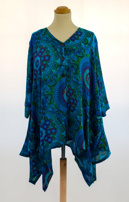 A blue bohemian blouse with a bold paisley pattern and an asymmetrical hem.