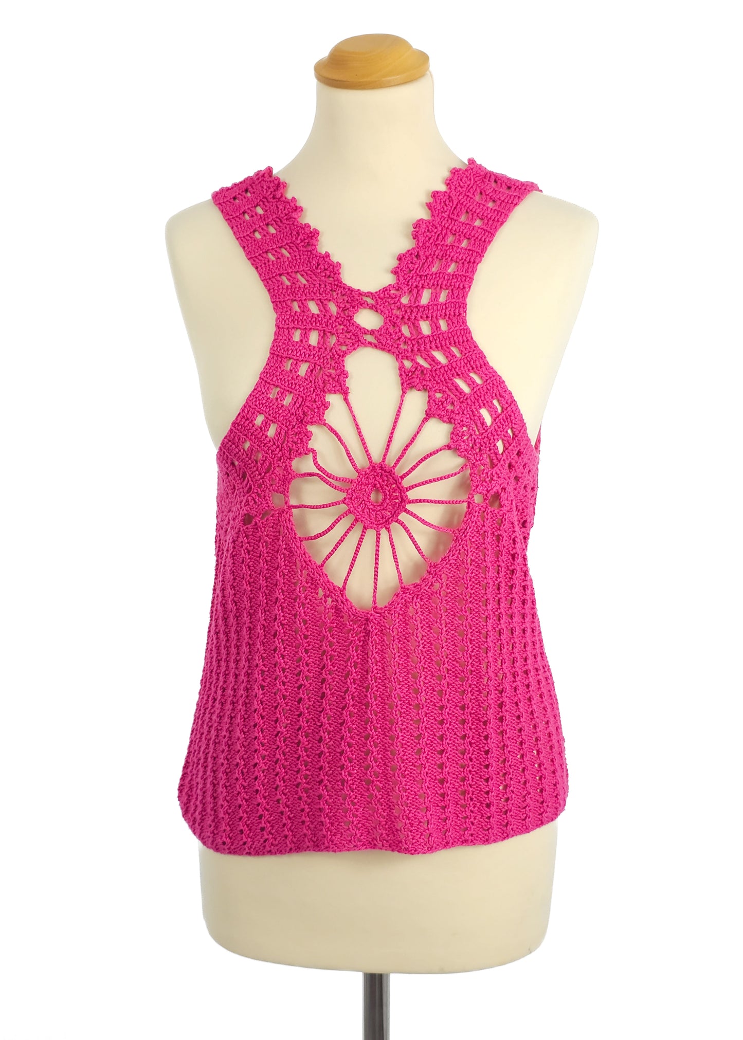 Pink crochet tank top with intricate openwork design on a mannequin.