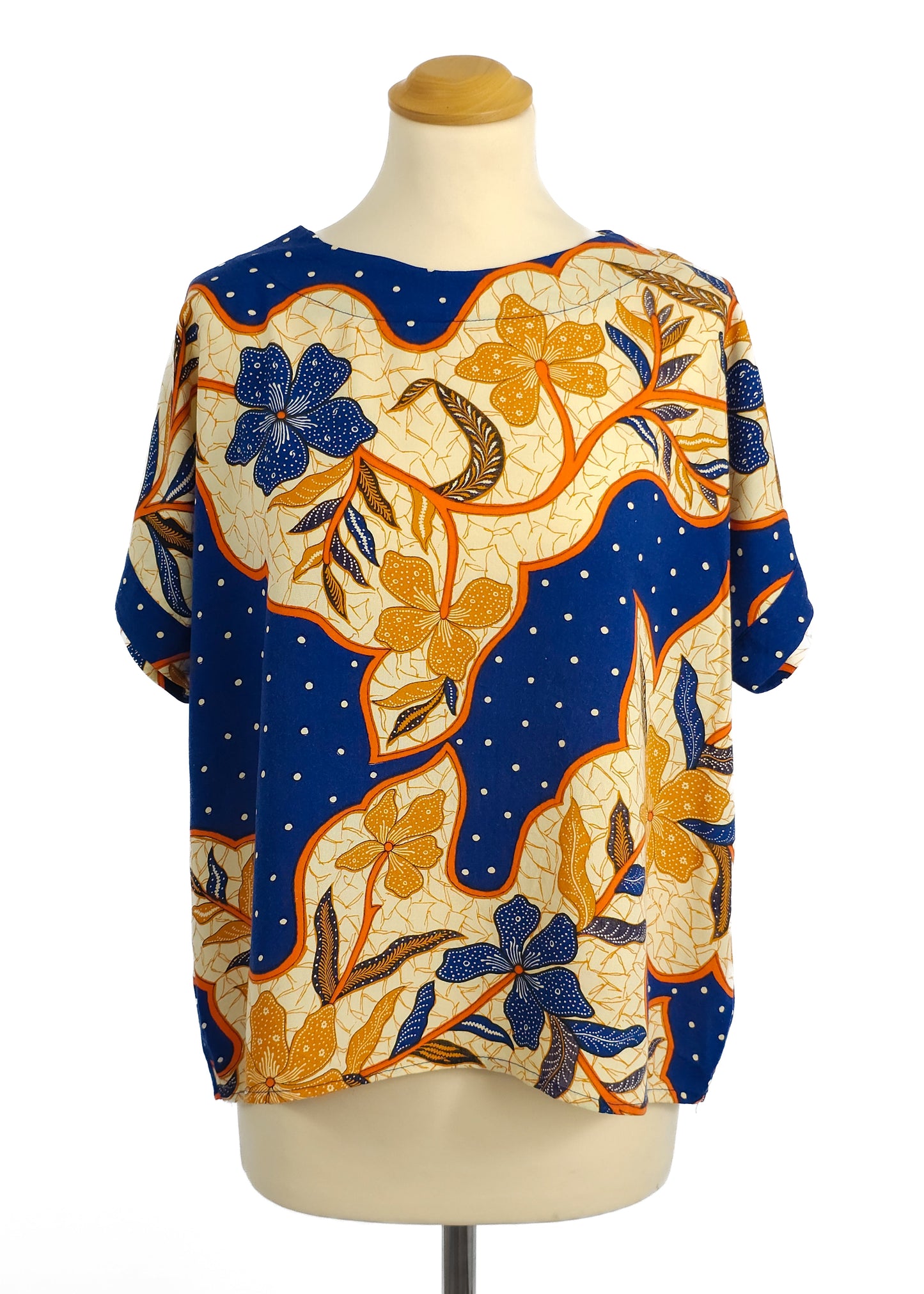 A colorful T-shirt with a blue base and vibrant floral pattern.