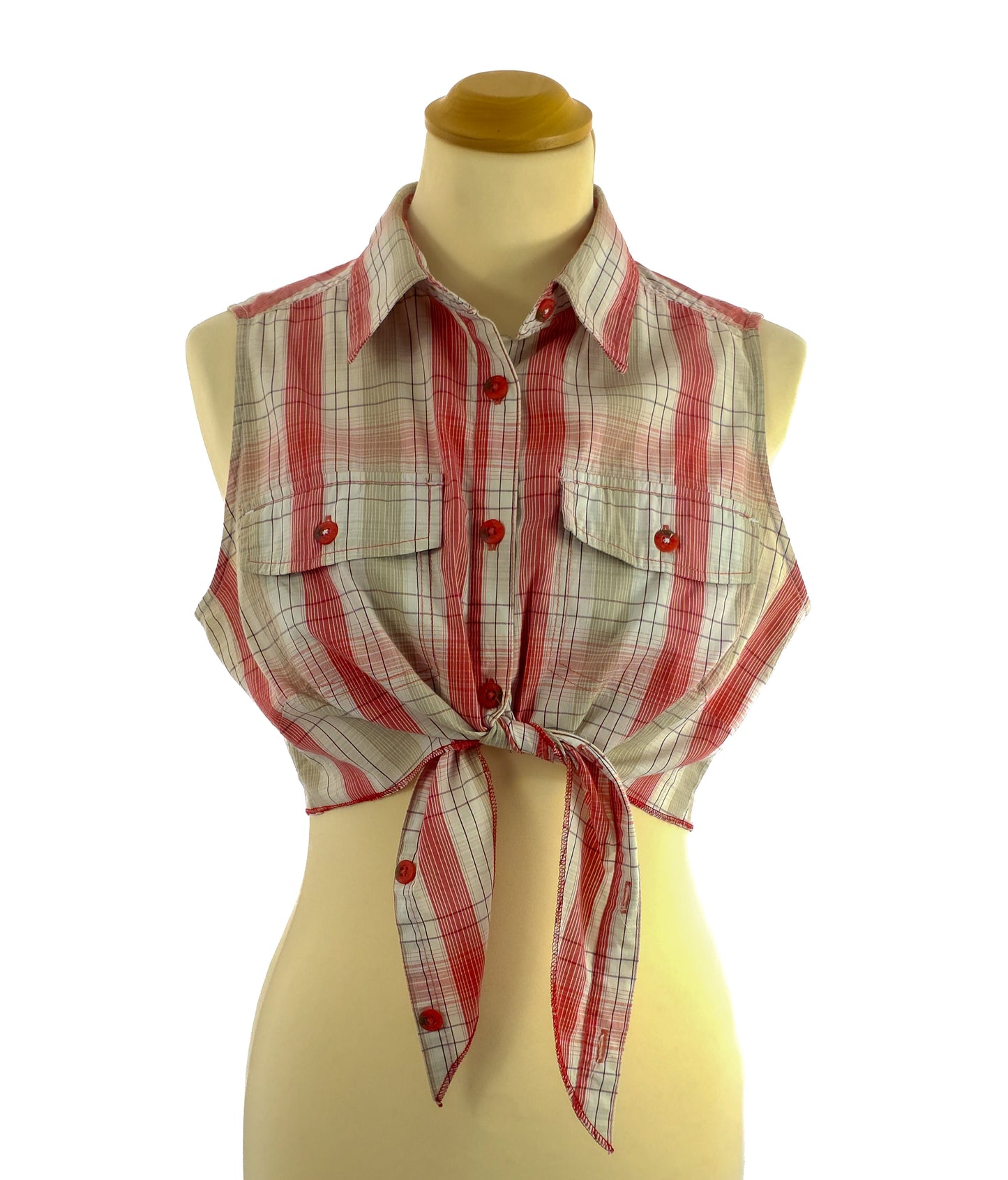 A sleeveless plaid top with a tie-front design and button-down closure.