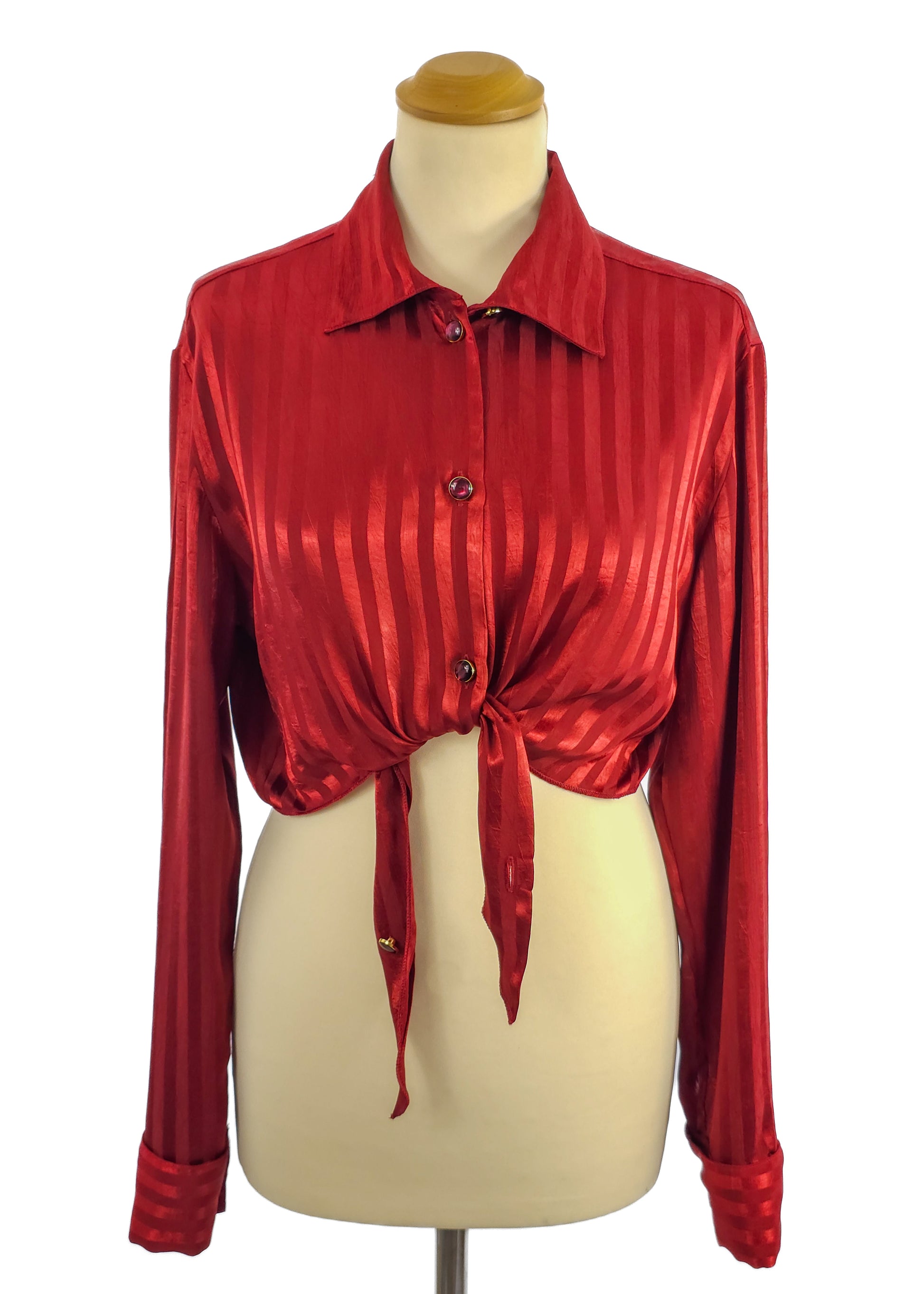 Red satin long-sleeved shirt with a tie-front design on a mannequin.