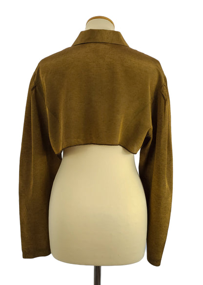A cropped brown jacket with long sleeves, shown from the back on a mannequin. The jacket features a collar and an elegant, simple design.