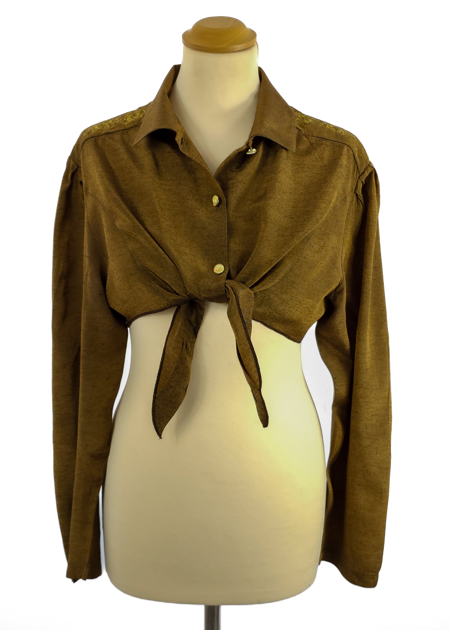Brown long-sleeve tie-front top on a mannequin with collar and gold buttons.