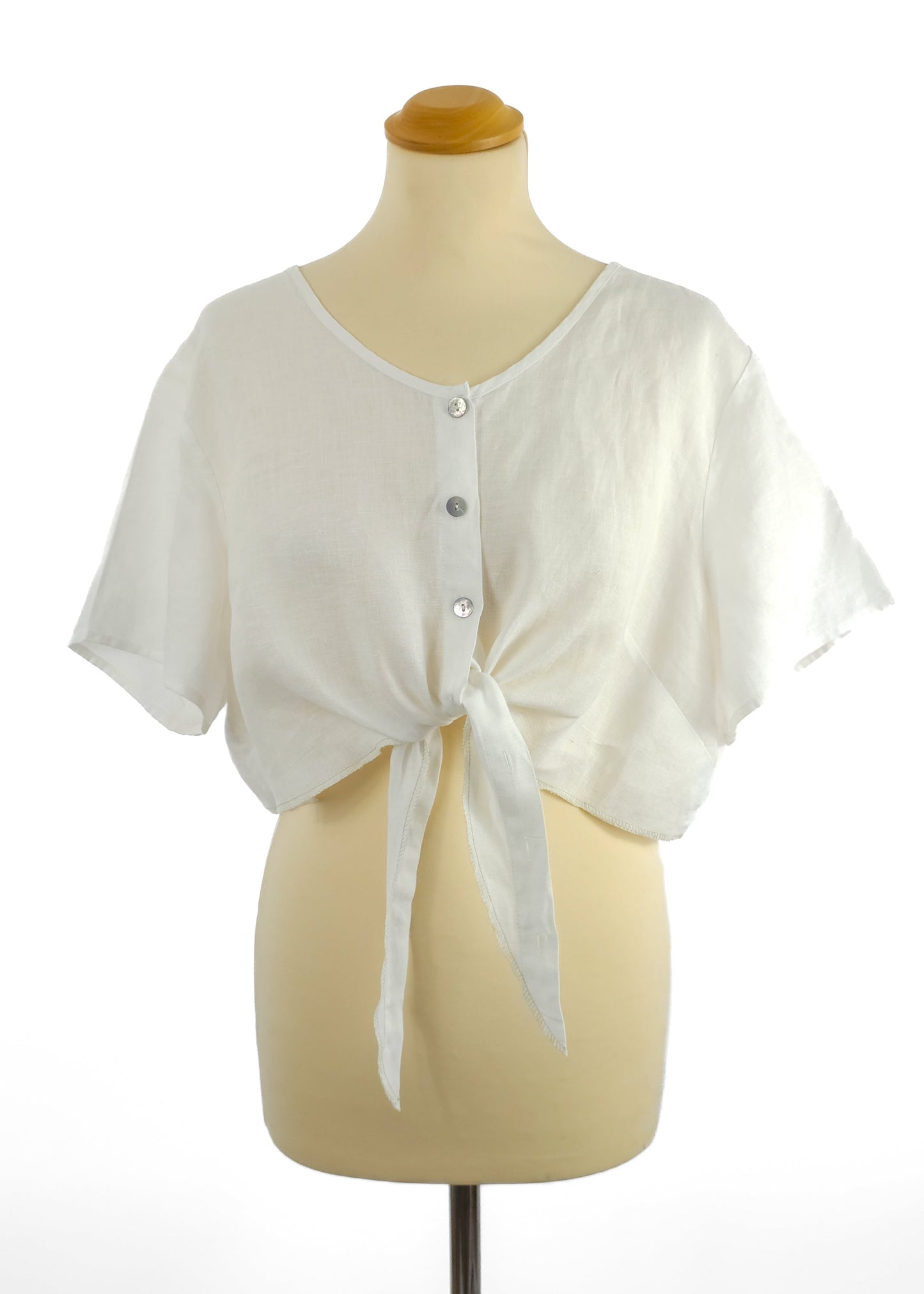 White button-down crop top with tie front on a mannequin.