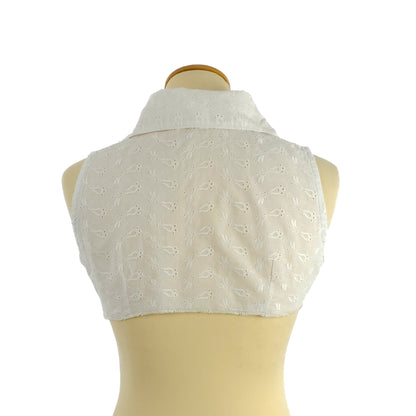 White sleeveless eyelet lace cropped vest with a high collar, displayed on a mannequin, showing the back view.