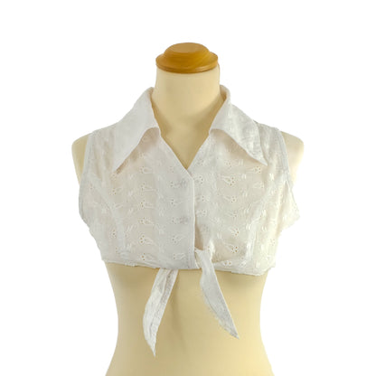 White sleeveless eyelet tie-front top on a mannequin.