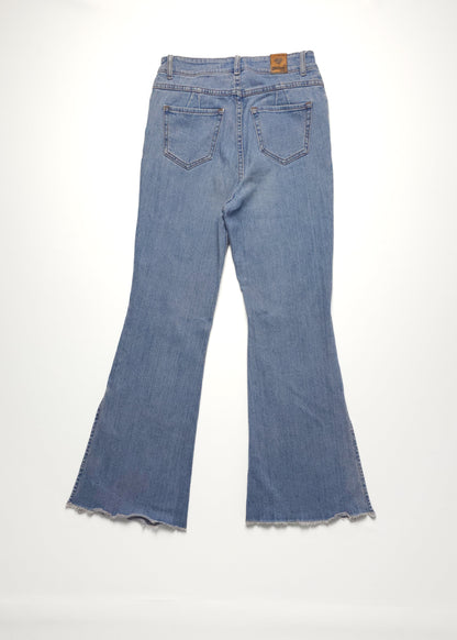 Blue denim bell-bottom jeans with frayed hem and back pockets, laid flat on a white background.