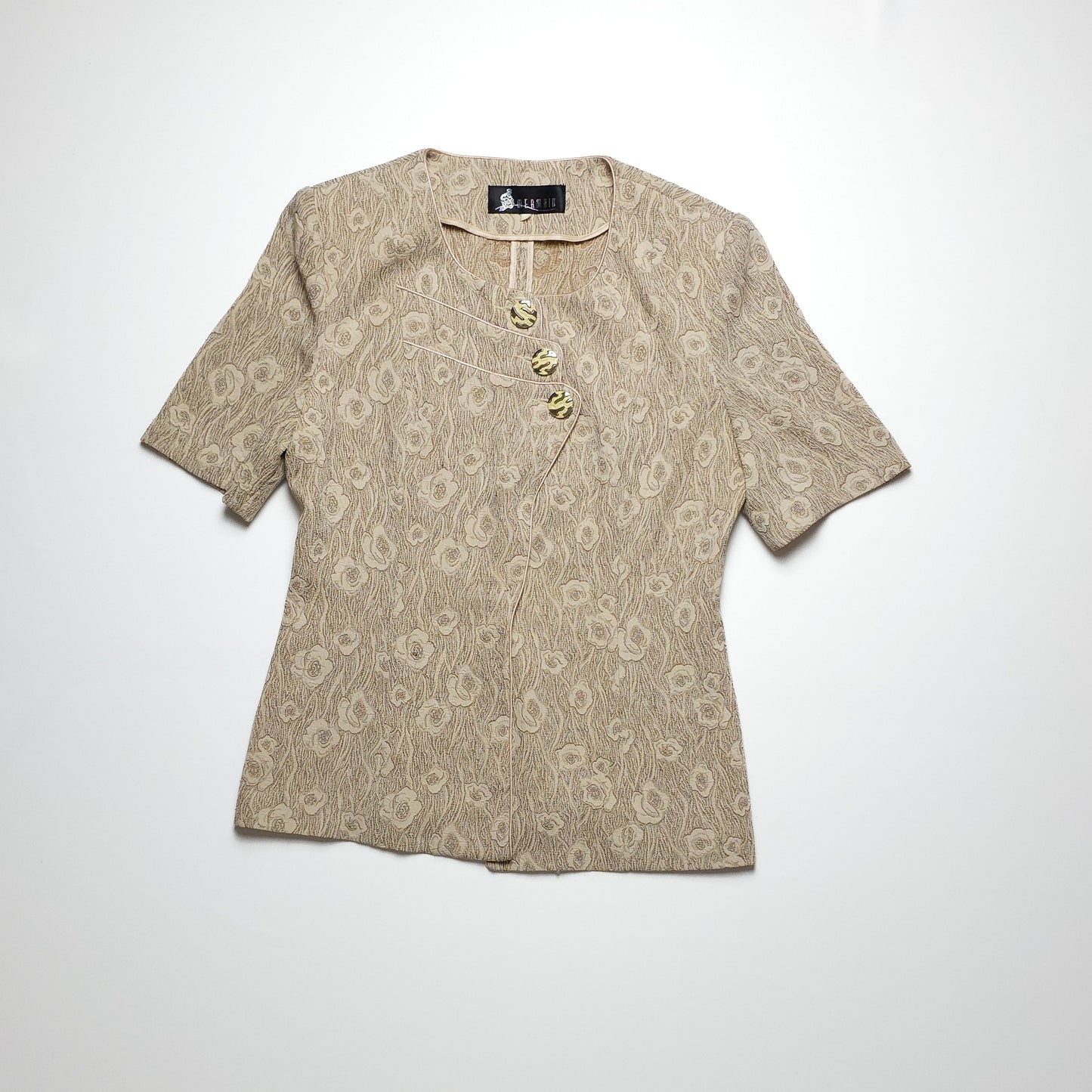 Vintage beige blouse with short sleeves and decorative buttons.